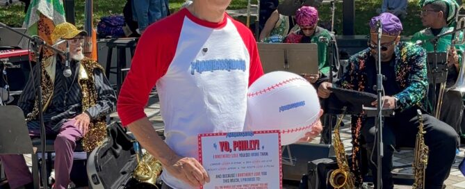 Andy Toy holding a copy of the Phambassador pledge outside of Calder Gardens