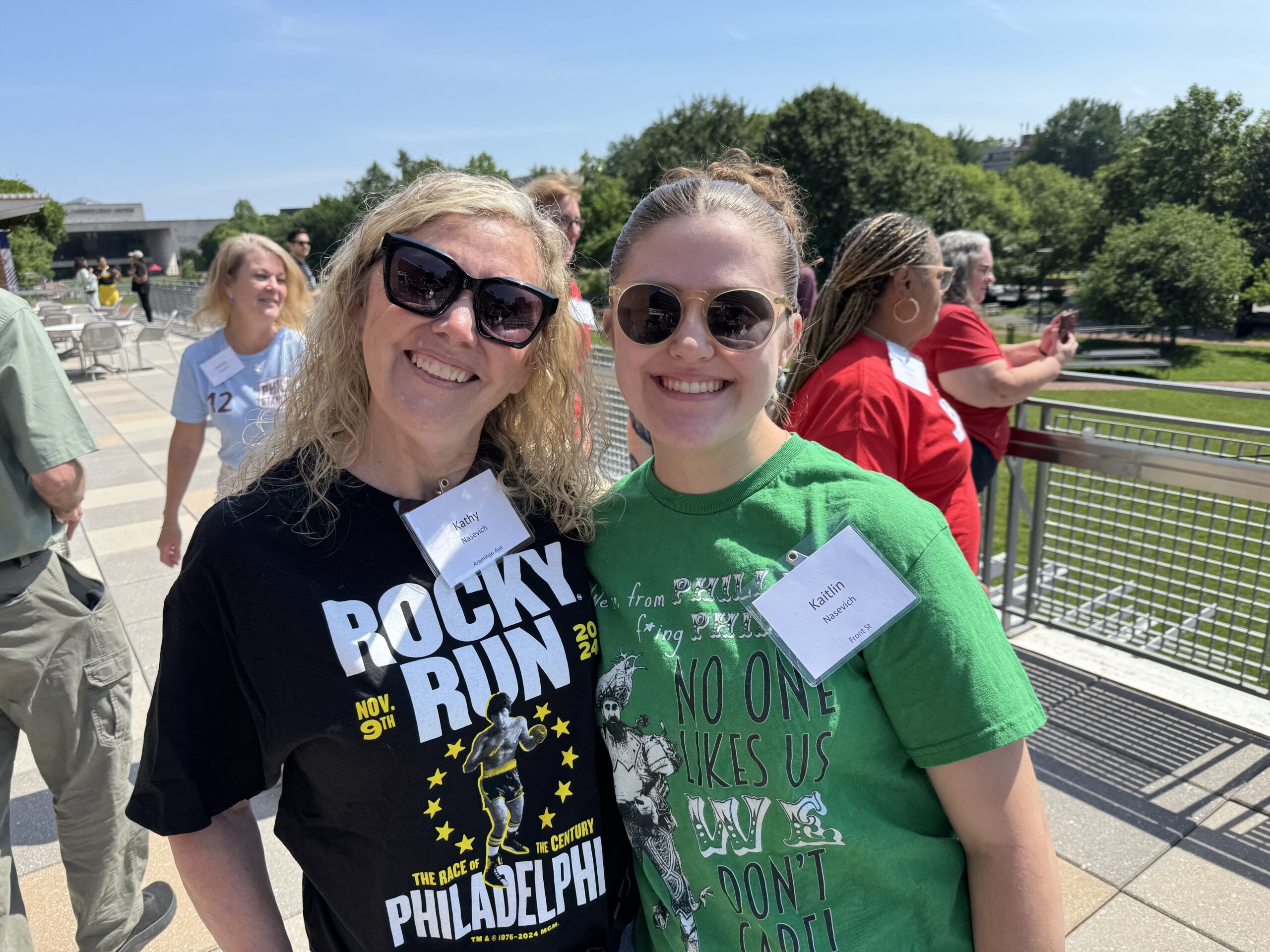 Two white women, Kathy and Kaitlin Nasevich, wearing their Philly gear at Pham Camp